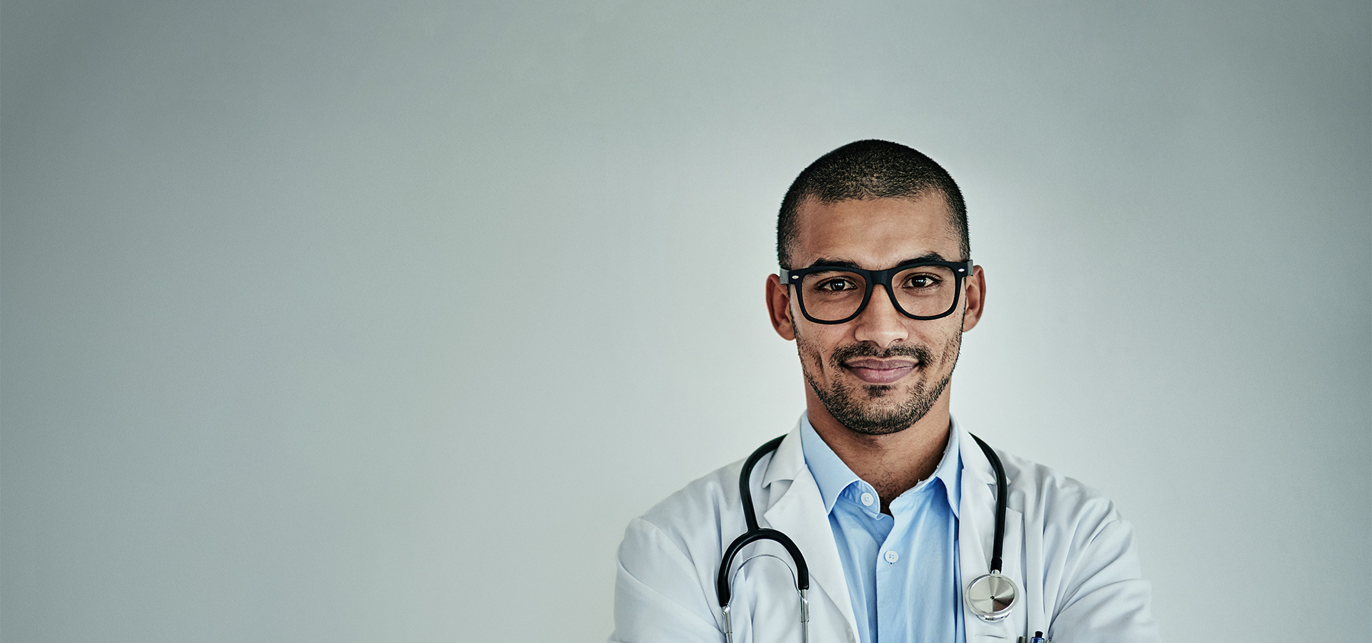 Physician crossing his arms and smiling.