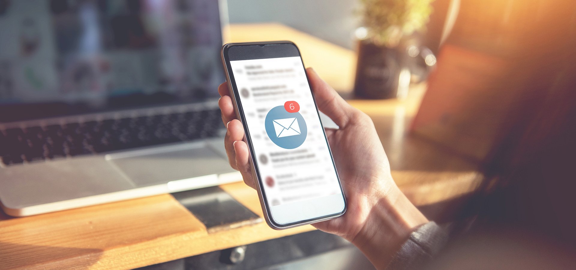 Woman holding phone checking email messages