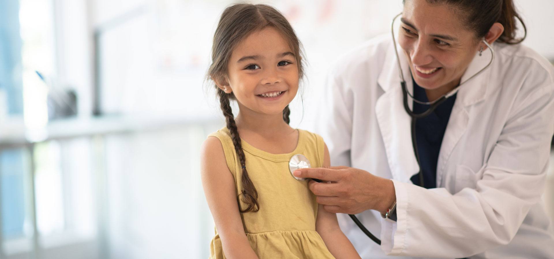 Female doctor with a girl patient