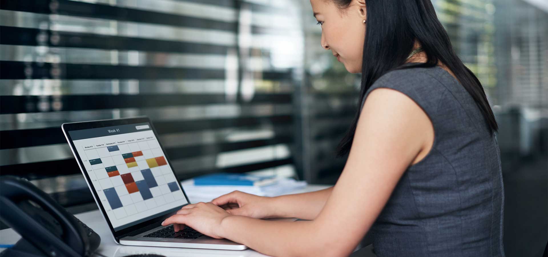 woman looking at calendar on laptop