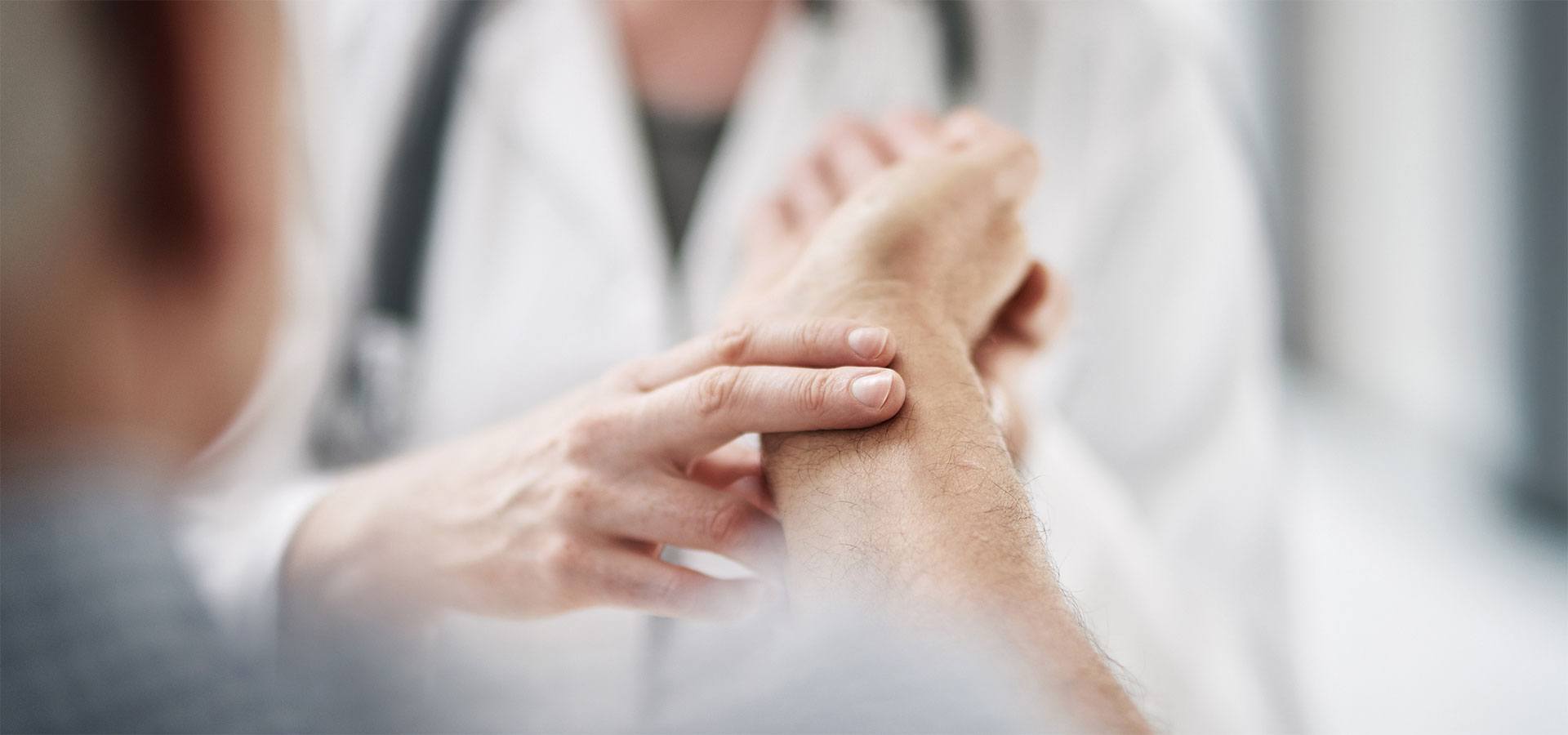 Nurse checking pulse on gentleman