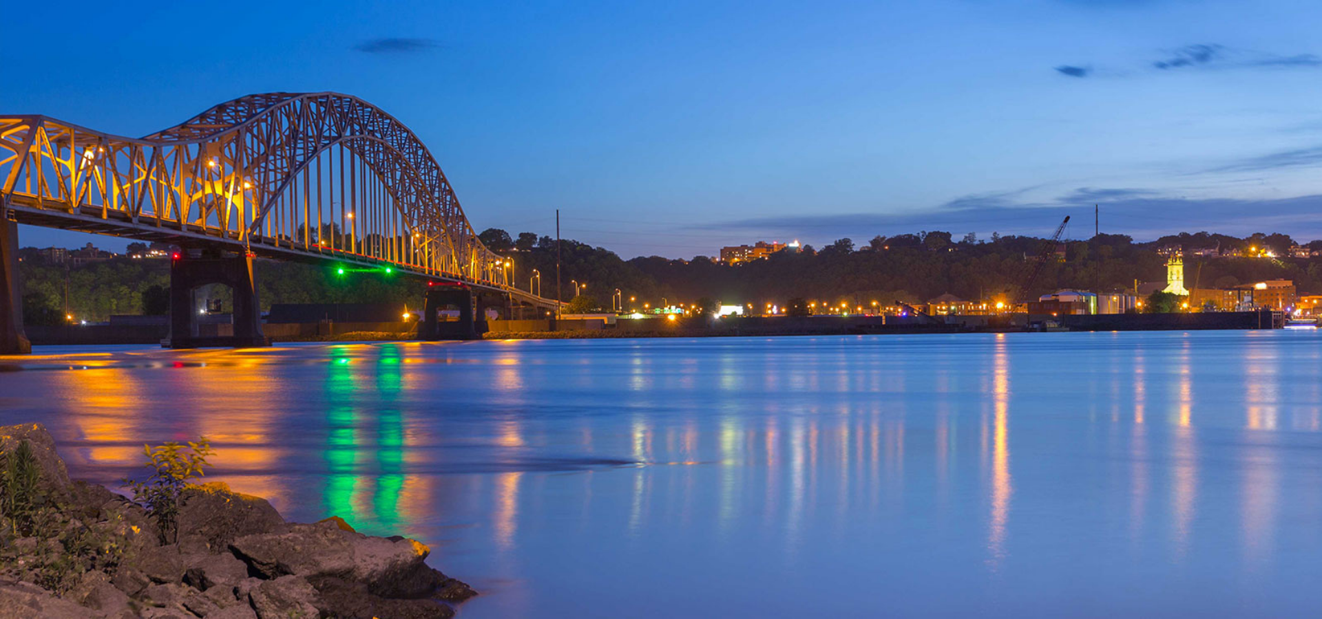 bridge with lights reflecting over water