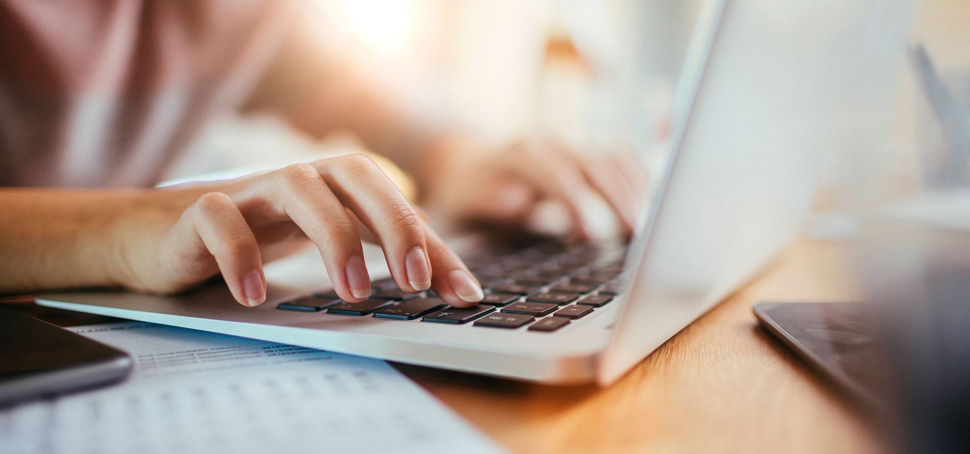 Woman typing on a laptop computer