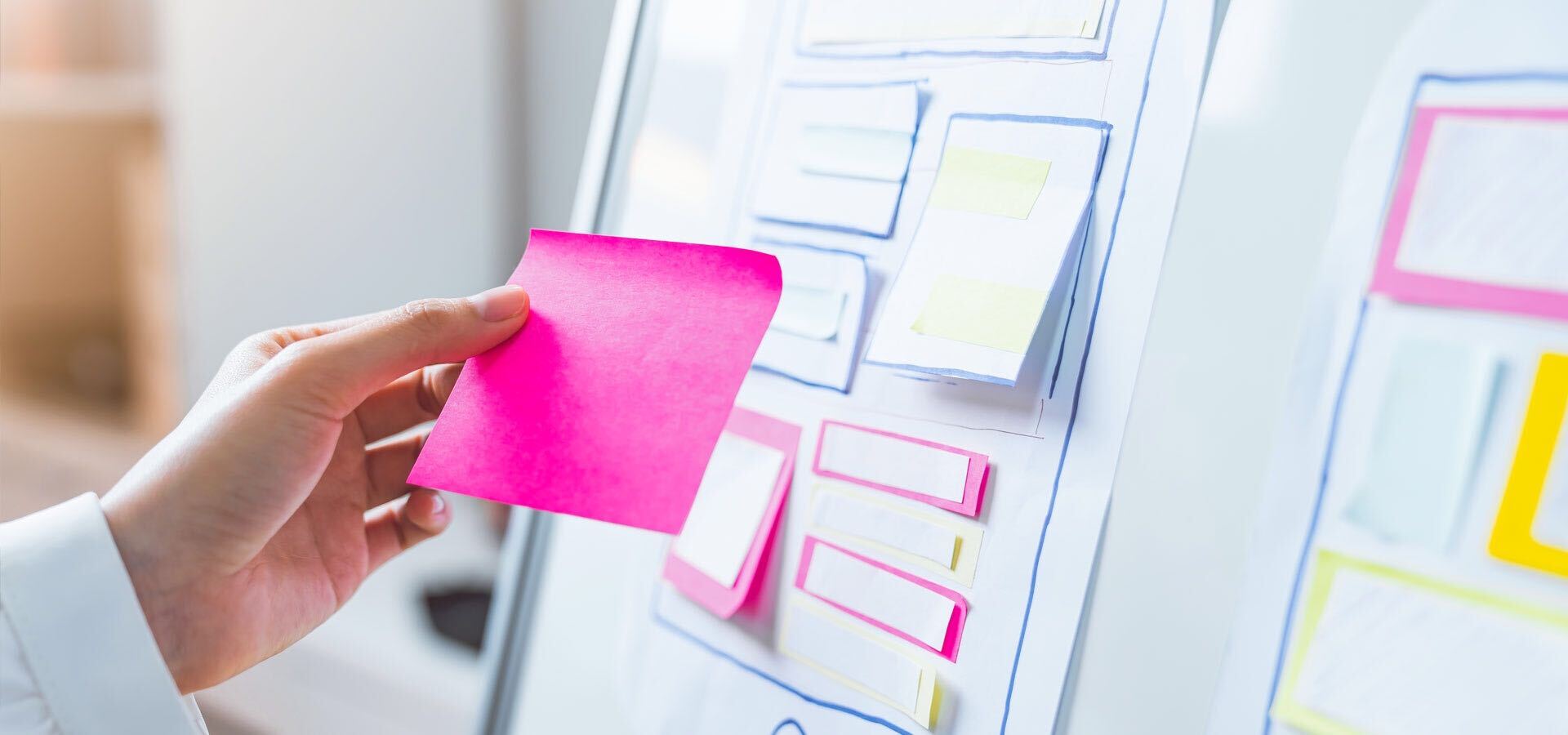 Hand holding a sticky note