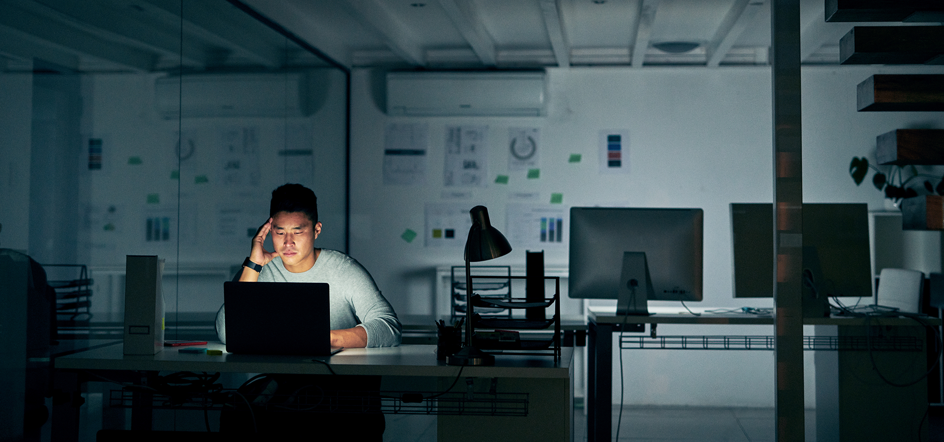 Man sitting alone at table with laptop.