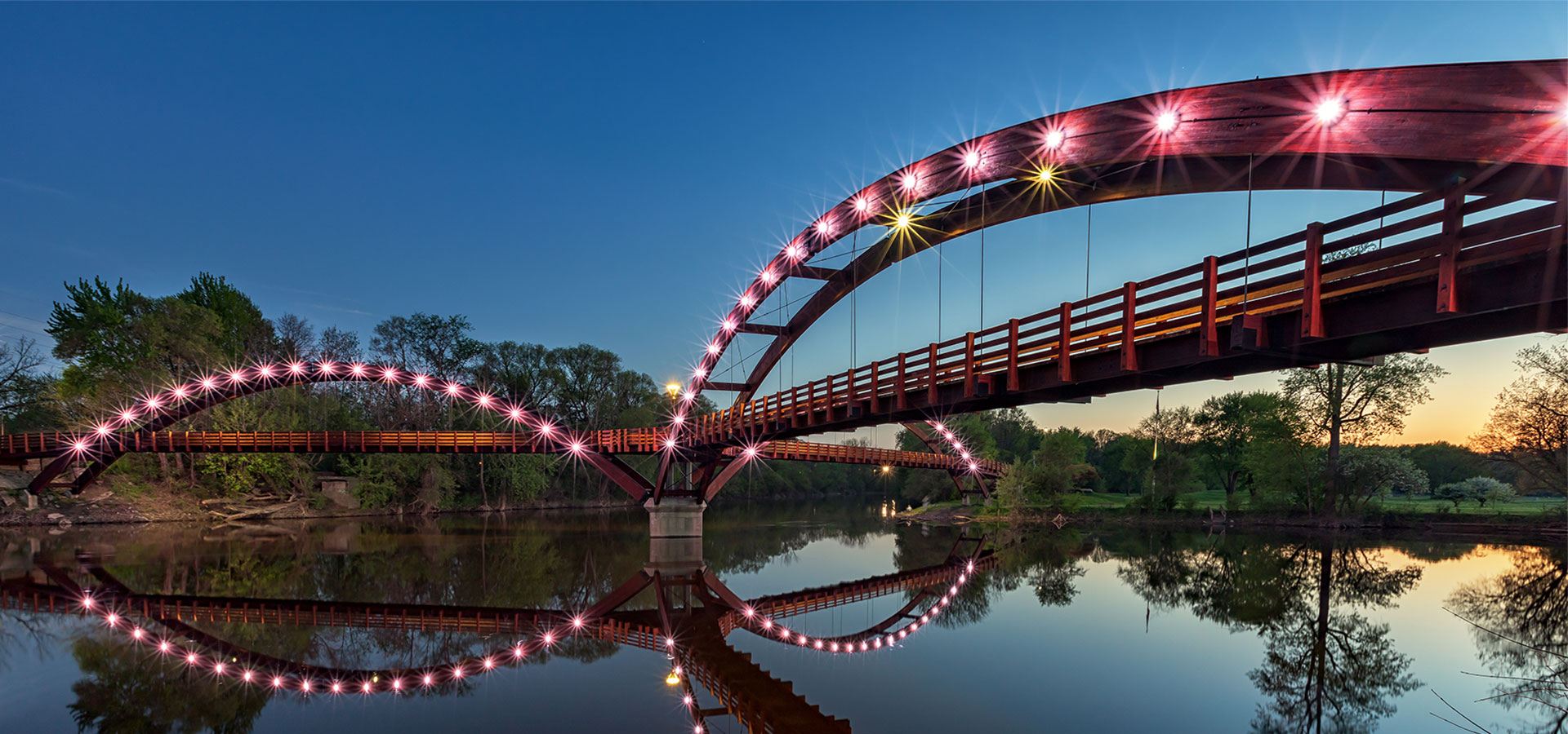 bridge reflects in the still river