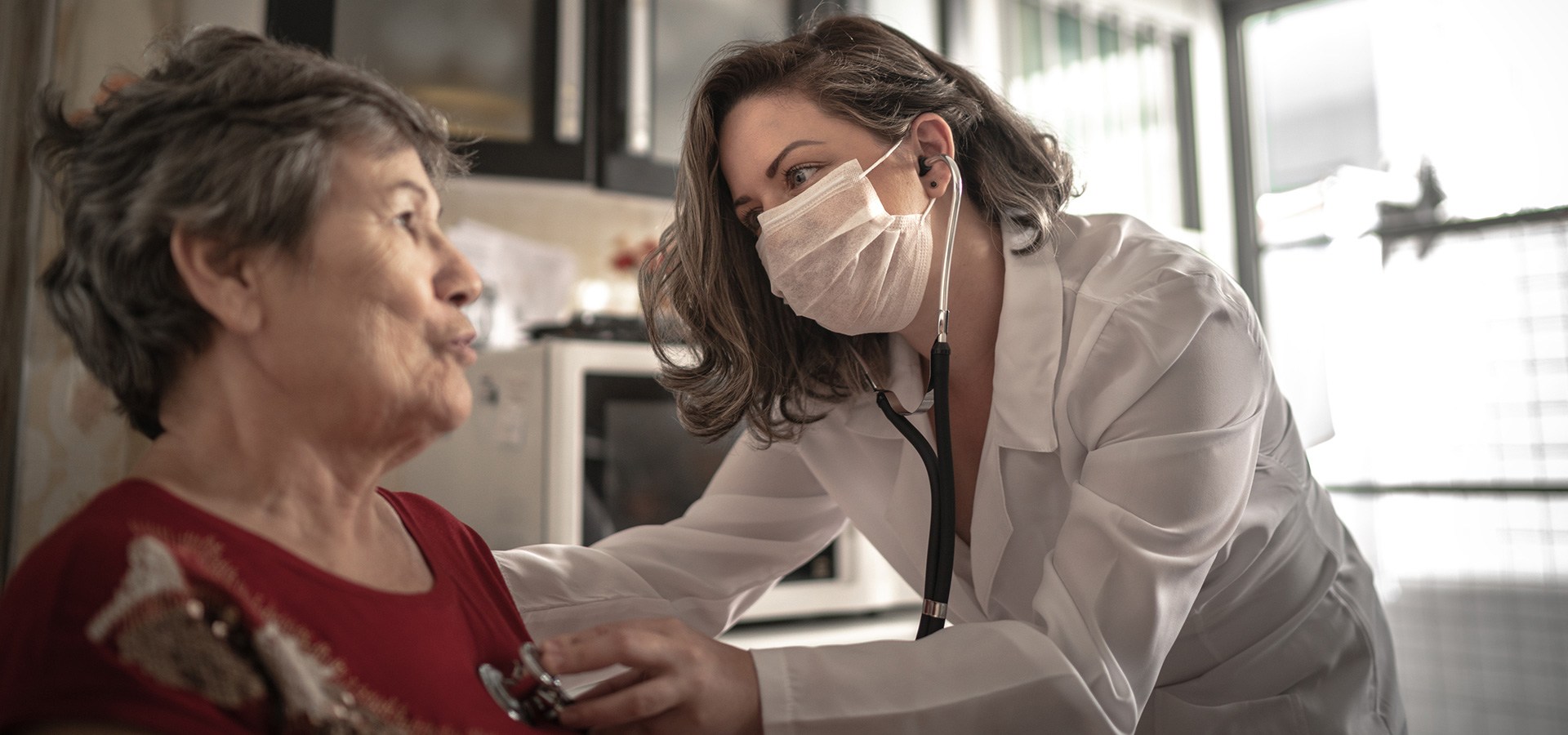 Health visitor and a senior woman during home visit