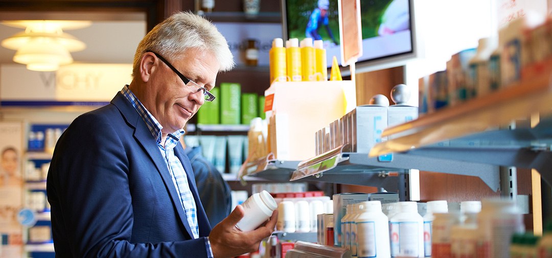 Man looking at prescription bottle