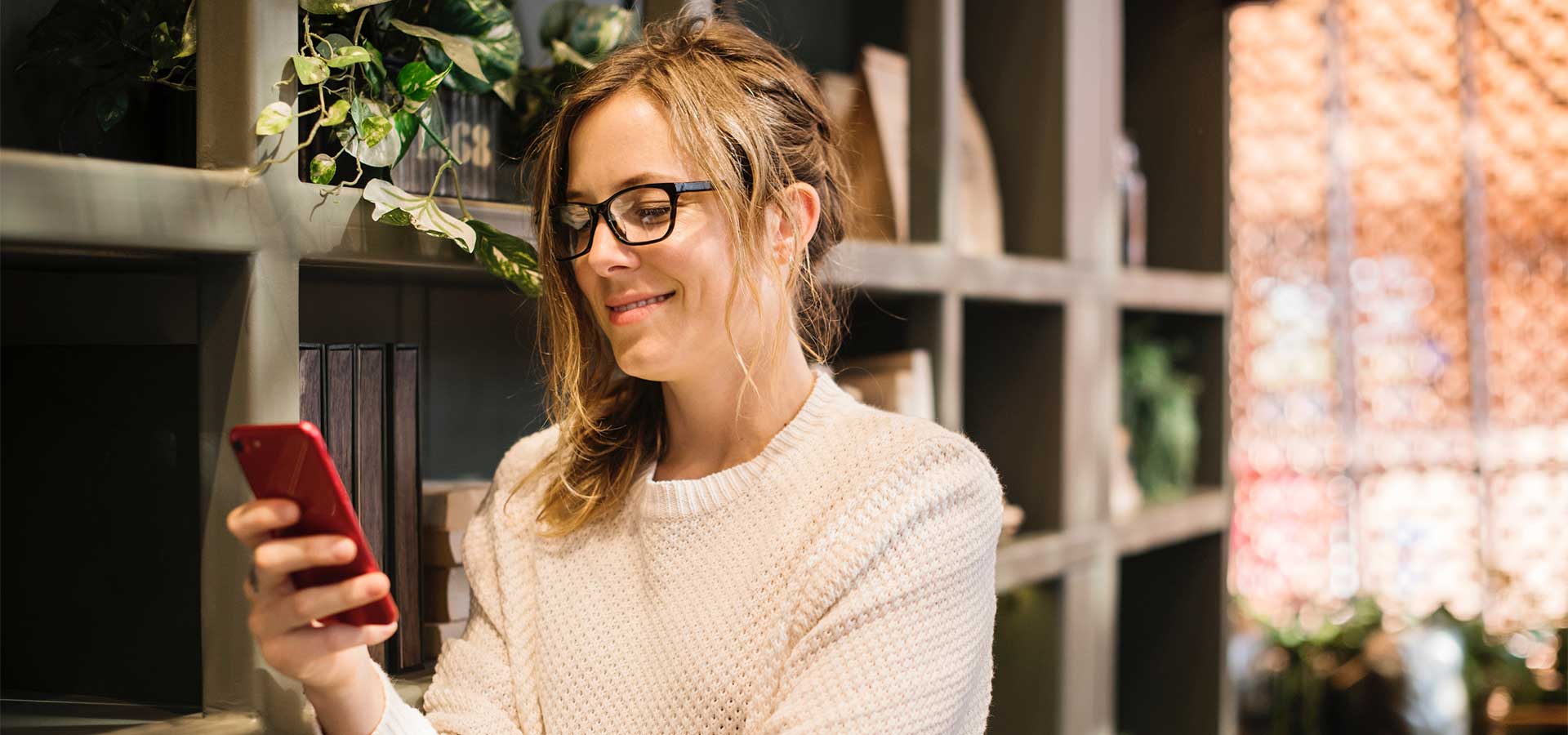 woman smiling at cell phone