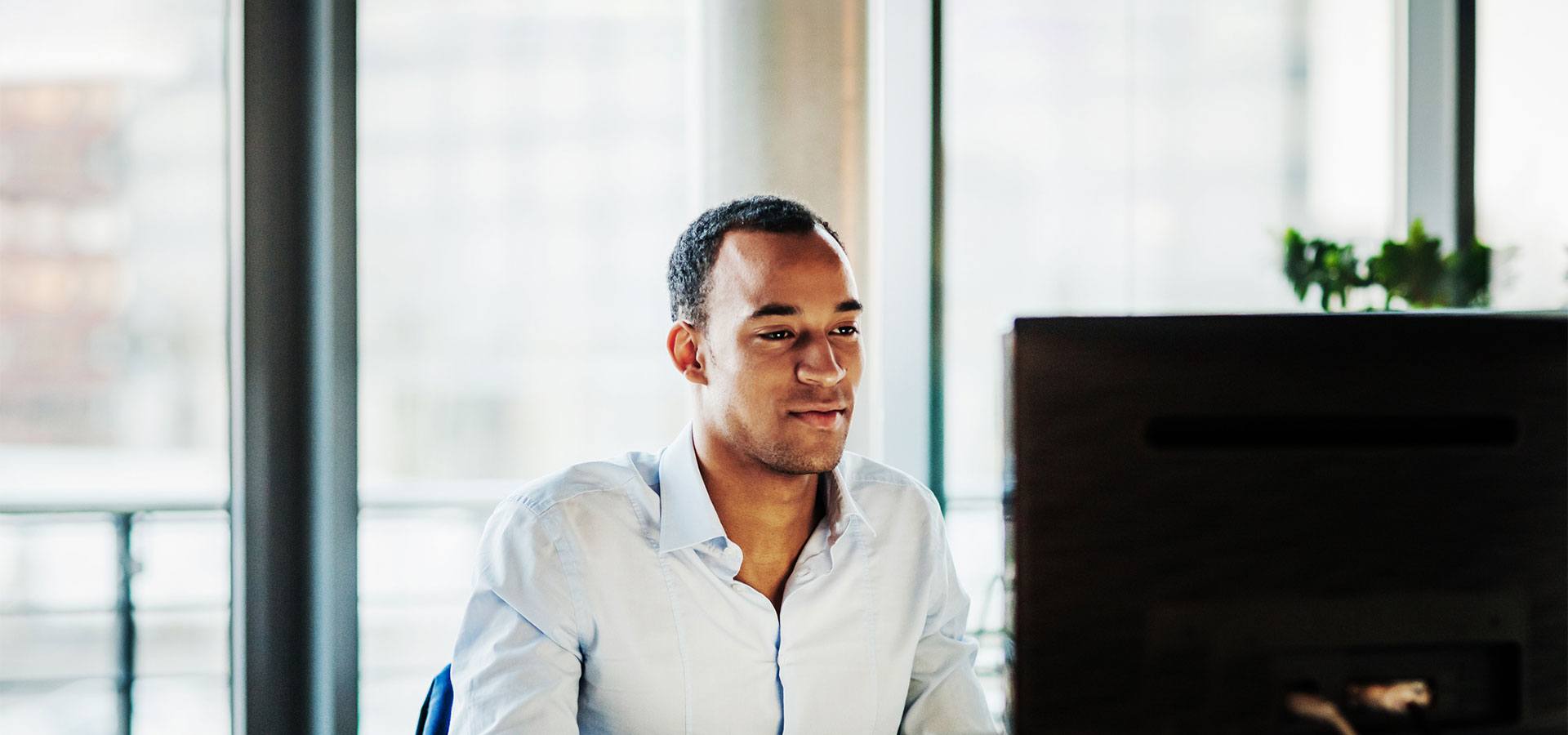 young man looking at computer screen